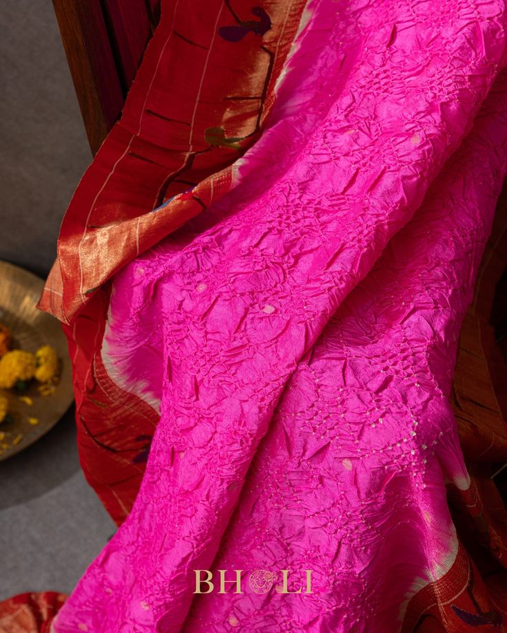 Add a touch of quirky elegance to your wardrobe with our Handtied bandhini Authentic Pure Silk handwoven mor-tota Yeola Paithani in rani pink. Made from luxurious silk, this bandhini piece is sure to make a statement with its playful color and traditional handwoven design. Perfect for any special occasion. (Limited quantities available!) Pink Chikankari Embroidered Dupatta In Slub Silk, Pink Cotton Silk Traditional Wear For Navratri, Navratri Pink Cotton Silk Traditional Wear, Pink Slub Silk Dupatta For Transitional Season, Pink Cotton Silk Traditional Wear For Transitional Season, Transitional Pink Cotton Silk Traditional Wear, Pink Cotton Silk Traditional Wear With Dupatta, Pink Cotton Silk Traditional Wear For Festive Season, Festive Pink Cotton Silk Traditional Wear