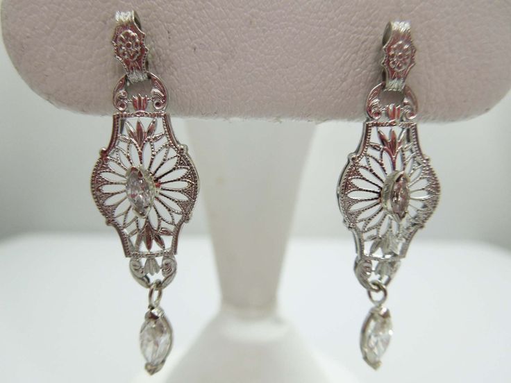 "For Sale: (1) g650 Stunning Vintage Pair of 14kt White Gold Filigree and Diamond Dangle Earrings PLEASE READ ENTIRE DESCRIPTION BEFORE PURCHASING These are a pretty pair of marquise diamond earrings. Each earring is set in 14kt white gold and features a filigree design and .05ct marquise diamond in each center. For added flair, they also have a dangling .25ct marquise diamond as well. Perfect for an elegant night on the town. Screwback is stamped 14k. Would be a lovely birthday, Mother's Day, C White Gold Chandelier Earrings For Formal Occasions, Classic Pierced Chandelier Earrings For Formal Occasions, Formal Filigree Drop Diamond Earrings, Formal Filigree Diamond Drop Earrings, Classic Filigree Dangle Chandelier Earrings, Formal Diamond Filigree Earrings, Classic Filigree Chandelier Earrings, Classic Filigree Chandelier Dangle Earrings, Classic Formal Chandelier Earrings With Intricate Design