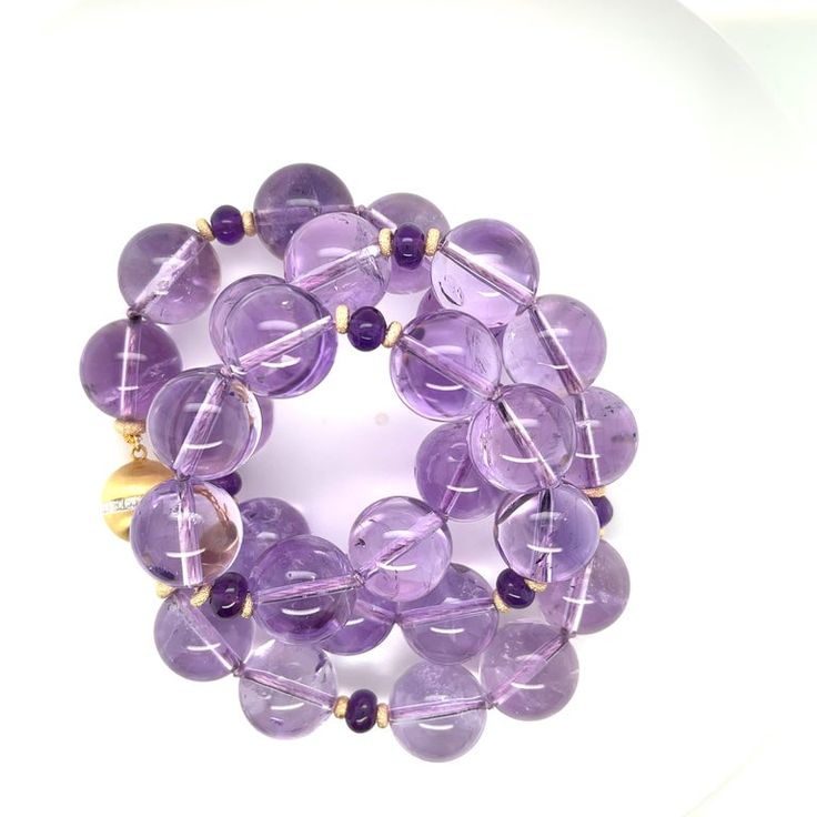 This gorgeous strand of beautifully matched Rose de France amethyst beads is sure to make you smile! Rose de France amethyst is known for its lovely pastel purple color, and these impressive 14mm round beads are simply stunning! Amethyst has been prized for centuries - not only for its undeniable beauty but also for the healing and stress-reducing properties it is believed to possess. These pretty gems have been hand knotted and strung on silk thread, and accented with 6mm round deep purple amet Luxury Purple Jewelry With Round Beads, Elegant Round Amethyst Beaded Bracelets, Rondelle Amethyst Gemstone Beads, Amethyst Rondelle Gemstone Beads, Purple Rondelle Gemstone Beads, Lavender Round Jewelry With Faceted Beads, Amethyst Gemstone Beads, Elegant Purple Faceted Beads Gemstones, Purple Faceted Beads Amethyst Gemstones