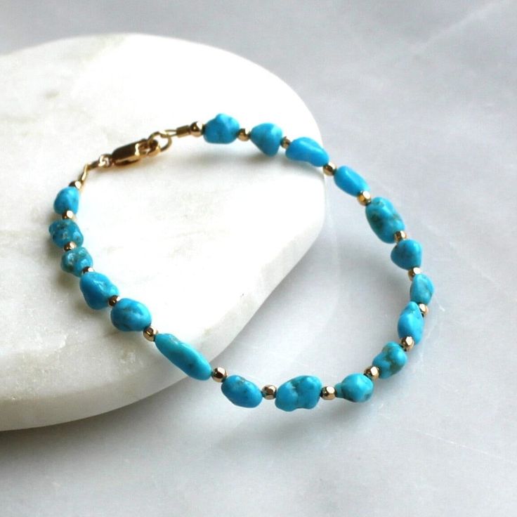 Gorgeous natural turquoise is hand strung to create this beaded bracelet.  It's accented with 14kt gold filled touches.  Turquoise is know as the talisman for luck! D E T A I L S *Hand strung genuine natural turquoise nuggets from Kingman, AZ *This turquoise is a vivid bright blue color  *14kt gold filled accent beads  *Fits up to a 6.5 inch wrist, optional extender available ∙ EXTRA LOVE ∙ Handcrafted just for you in sunny Arizona by a team of talented women. All of our jewelry comes gift packaged! We are happy to leave a note if this is a special gift, just let us know in the message box at checkout. PRODUCTION ∙ TIMES All items are made to order. Please check the estimated delivery in the shipping section for the most current production time. If you need it sooner, select a faster shipp Adjustable Turquoise Bracelet With Polished Beads, Turquoise Howlite Beaded Bracelets As A Gift, Turquoise Beaded Howlite Bracelets, Spiritual Turquoise Beaded Bracelets With Polished Beads, Spiritual Turquoise Bracelets With Polished Beads, Turquoise Hand-strung Stretch Bracelet, Turquoise Beaded Healing Bracelets, Turquoise Howlite Beaded Bracelets, Hand-strung Howlite Jewelry With Round Beads