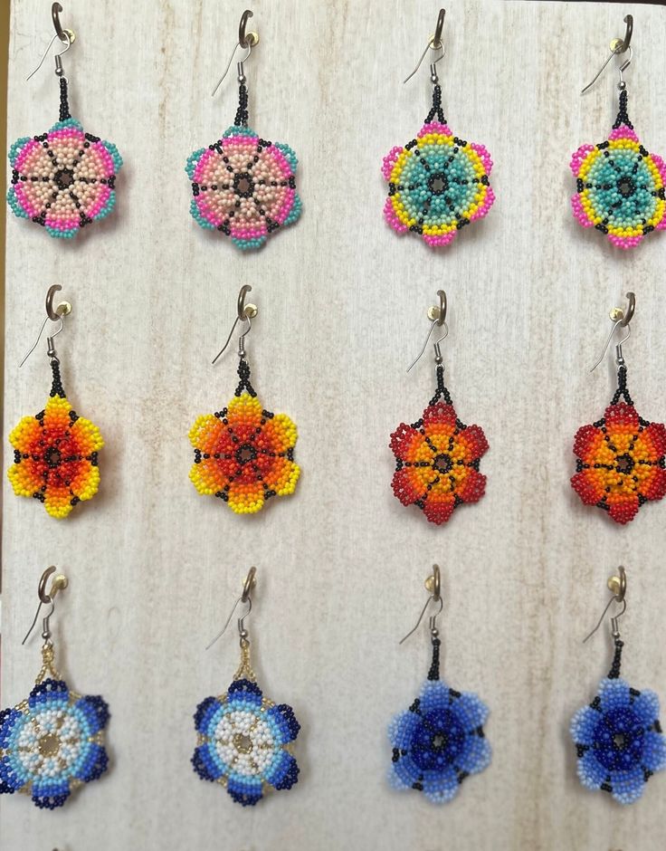 Traditional Mexican Handmade Huichol chaquira (beaded) earrings made by Mexican artisans in the Mexican state of Chipas. The earrings are lightweight, colorful and sure to bring you lots of compliments. Multicolor Beaded Flower Drop Earrings, Multicolor Beaded Drop Flower Earrings, Multicolor Handmade Flower Earrings, Multicolor Flower-shaped Earrings With Colorful Beads, Beaded Multicolor Flower Earrings For Summer, Handmade Artisan Multicolor Flower Earrings, Handmade Multicolor Flower Earrings With Round Beads, Artisan Multicolor Handmade Flower Earrings, Artisan Handmade Multicolor Flower Earrings