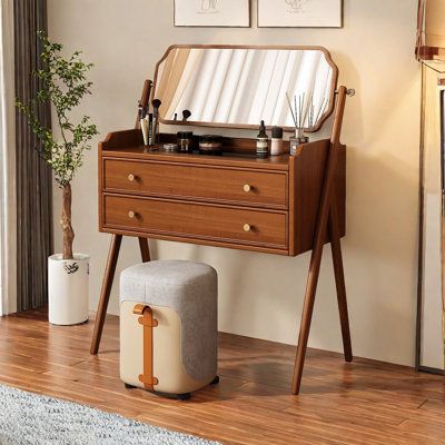 an old fashioned record player sitting on top of a wooden table next to a stool