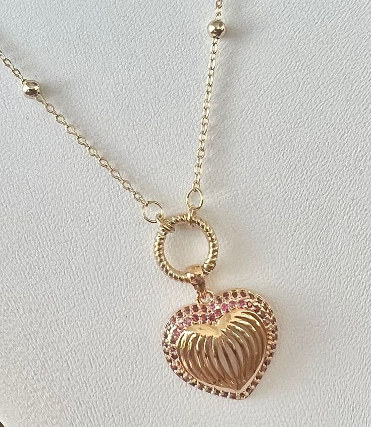 The Barbie Love Necklace is a stylish and endearing piece inspired by the necklace worn on Margot Robbie in the iconic Barbie Movie. Featuring a gold-filled heart shaped pendant surrounded by tiny pink gemstones on a dotted gold-filled chain, this necklace serves as a symbol of self love, positivity and the timeless appeal of Barbie. A perfect gift for anyone who adores Barbie or values the message of women empowerment. Available in multiple sizes Barbie Love, Heart Shaped Pendant, Barbie Movie, Bold Jewelry, Barbie Movies, Heart Shape Pendant, Pink Gemstones, Margot Robbie, Love Necklace