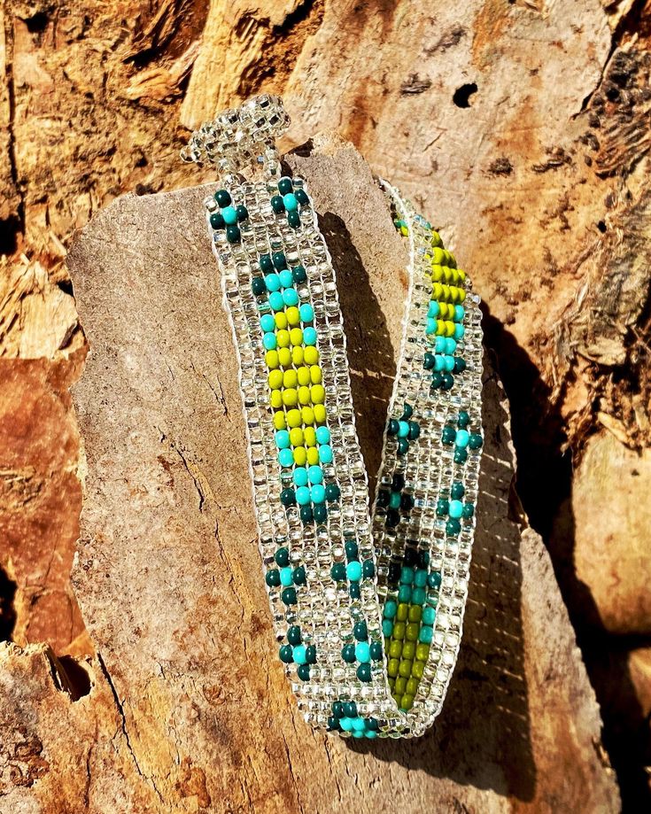 Green and Clear Pattern Seed Bead Bracelet delicately handmade by an indigenous Mayan family of women in Guatemala. This neutral-colored bracelet is a must have for a his and hers every day accessory! Makes for a great birthday gift, Christmas gift, holiday gift, stocking stuffer, friendship bracelet and a his/hers, his/his, hers/hers couples bracelet! *Please note that all of our items are handcrafted and unique to each piece. Also, colors may vary slightly based on your device. Like what you s Bohemian Jubilee Beaded Bracelets As Gift, Artisan Green Beaded Bracelets For Beach, Bohemian Festival Bracelets With Jubilee Detail, Bohemian Silver Friendship Bracelets With Tiny Beads, Beaded Bohemian Friendship Bracelet, Bohemian Adjustable Jubilee Bracelet, Bohemian Green Beaded Crystal Bracelet, Bohemian Green Crystal Bracelet For Beach, Handmade Southwestern Green Beaded Bracelets