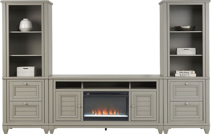 an entertainment center with built - in fireplace and bookcases