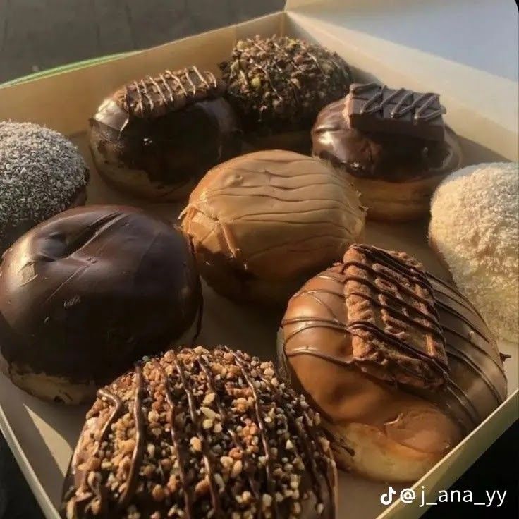 a box filled with lots of different flavored donuts