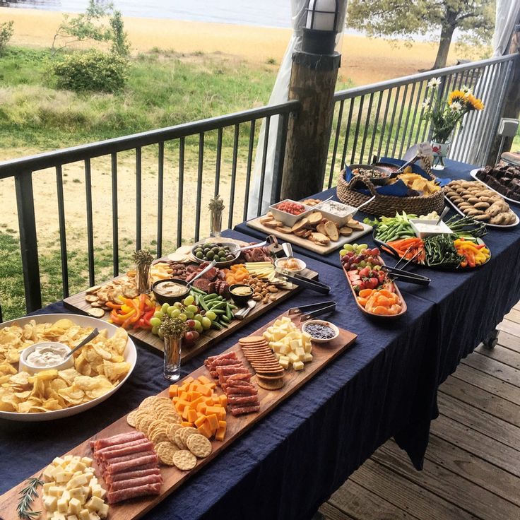 a table full of food sitting on top of a wooden deck