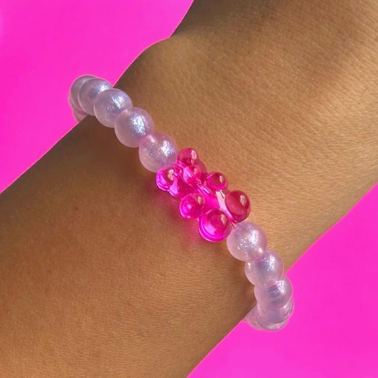 Adorable Jumbo Gummy Bear Shimmer Bracelet. Made using Hot Pink Acrylic Gummy Bear, 8mm Purple Shimmer acrylic beads, on 1mm durable elastic cord. You will receive (1) Bracelet ✨Sizing Siggestions✨ * Child 2-4yrs 5.0"   * Child 5-7yrs 5.5"  * Child 8-10yrs 6.0" (also fits XS Adult sz) * Adult S 6.5"  * Adult M 7.0" * Adult L 7.5" * Adult XL 8.0" * Adult XXL 8.5" check out my other gummy bear accessories, earrings, phone strap, phone charms!  free shipping at $35 If you have any questions, feel f Adjustable Kawaii Beaded Bracelet For Birthday, Pink Hypoallergenic Friendship Bracelets For Birthday, Hypoallergenic Pink Friendship Bracelets For Birthday, Playful Pink Beaded Bracelets As Gift, Casual Plastic Wristband Gift, Sweet Pink Plastic Jewelry, Cute Plastic Bracelets For Birthday, Cute Plastic Beaded Bracelets For Birthday, Cute Plastic Bracelets For Gifts