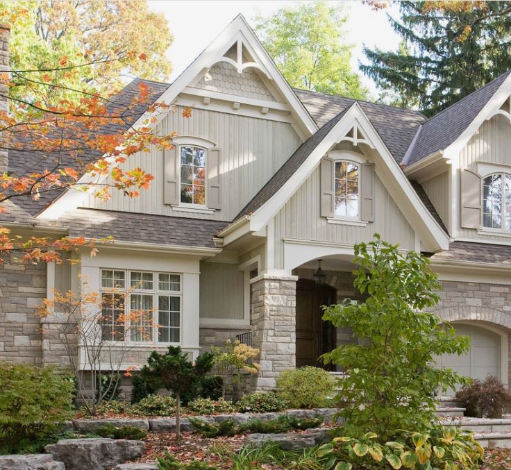 a large house with lots of windows and landscaping