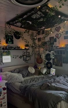 a bed room with a neatly made bed and lots of pictures on the wall