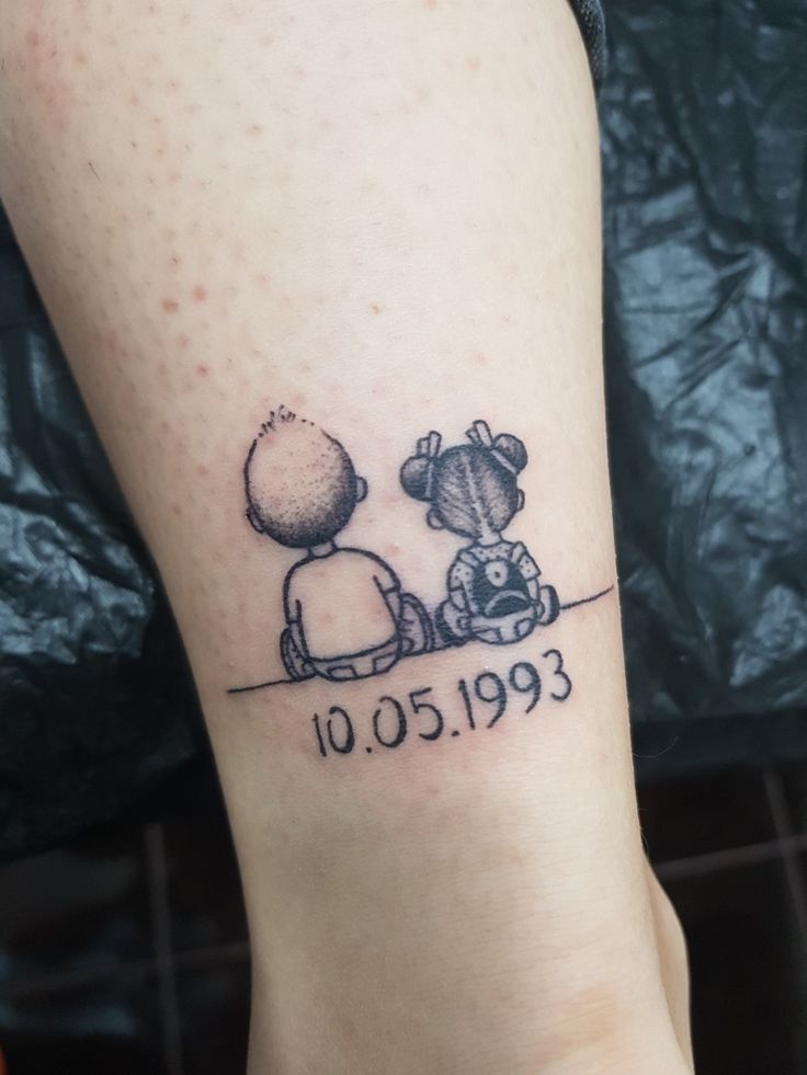 a tattoo on the leg of a person with a dog and cat sitting next to each other