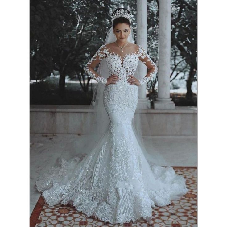 a woman in a wedding dress posing for the camera with her hands on her hips