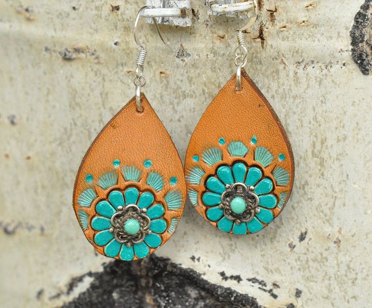 These earrings have vintage turquoise and sterling silver pieces mounted on a leather earring.  Hand stamped, dyed, and painted, the floral design is bright and cheery! 2¼" long including the ear wire, 1" wide. Handmade Turquoise Leather Earrings, Handmade Leather Turquoise Earrings, Handmade Leather Earrings In Turquoise, Bohemian Turquoise Leather Earrings, Blue Bohemian Leather Earrings, Bohemian Blue Leather Earrings, Blue Leather Bohemian Earrings, Turquoise Bohemian Hand Painted Jewelry, Bohemian Turquoise Hand Painted Jewelry