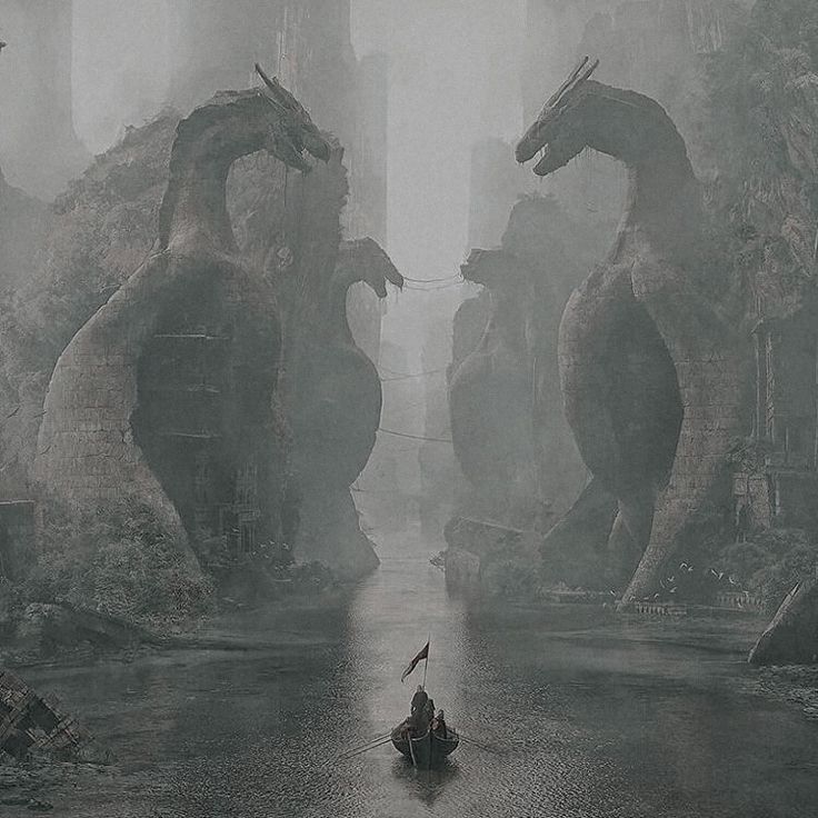 two dragon statues standing in the middle of a river surrounded by tall, rocky mountains