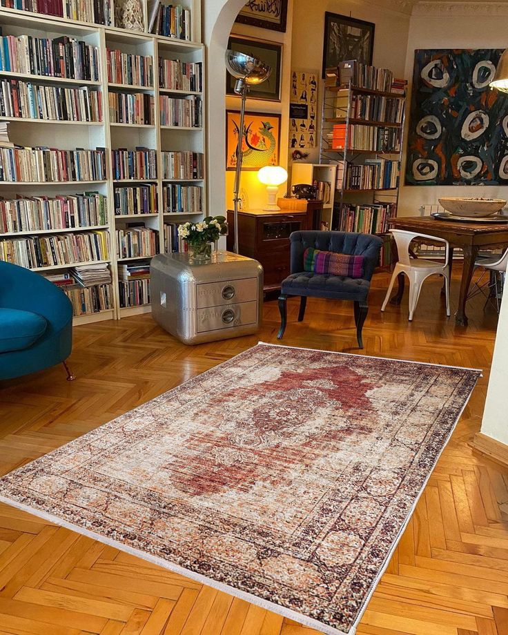 a living room filled with furniture and bookshelves covered in lots of bookcases