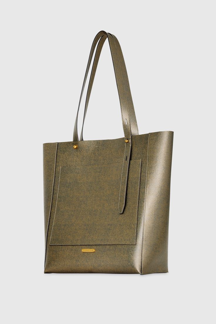 The perfect tote for carrying your everyday essentials. Our new Stevie North South Tote fits your laptop and so much more. Style# HF24TGFTNS-GOLD 100% Genuine Leather Antique Brass Hardware 11. 5" W X 13. 5" H X 5. 25" D Handle Drop: 11" Magnetic Snap Closure Interior Slip Pocket Exterior Slip Pocket Unlined Imported The photos featuring a model are for size reference only. Actual color and material may vary from what is depicted. | Rebecca Minkoff Stevie North South Tote Bag In Gold Gold Rectangular Bags For Work, Gold Rectangular Workwear Bags, Rectangular Gold Bags For Work, Gold Double Handle Work Bags, Gold Double Handle Shoulder Bag For Work, Modern Gold Bag For Work, Everyday Shoulder Bag With Magnetic Closure In Coated Canvas, Rectangular Coated Canvas Bag With Magnetic Closure, Gold Rectangular Coated Canvas Bags