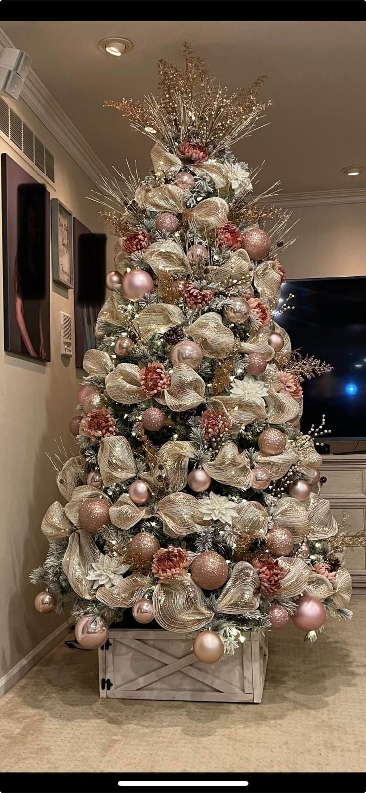 a decorated christmas tree in a living room with ornaments on the top and bottom half