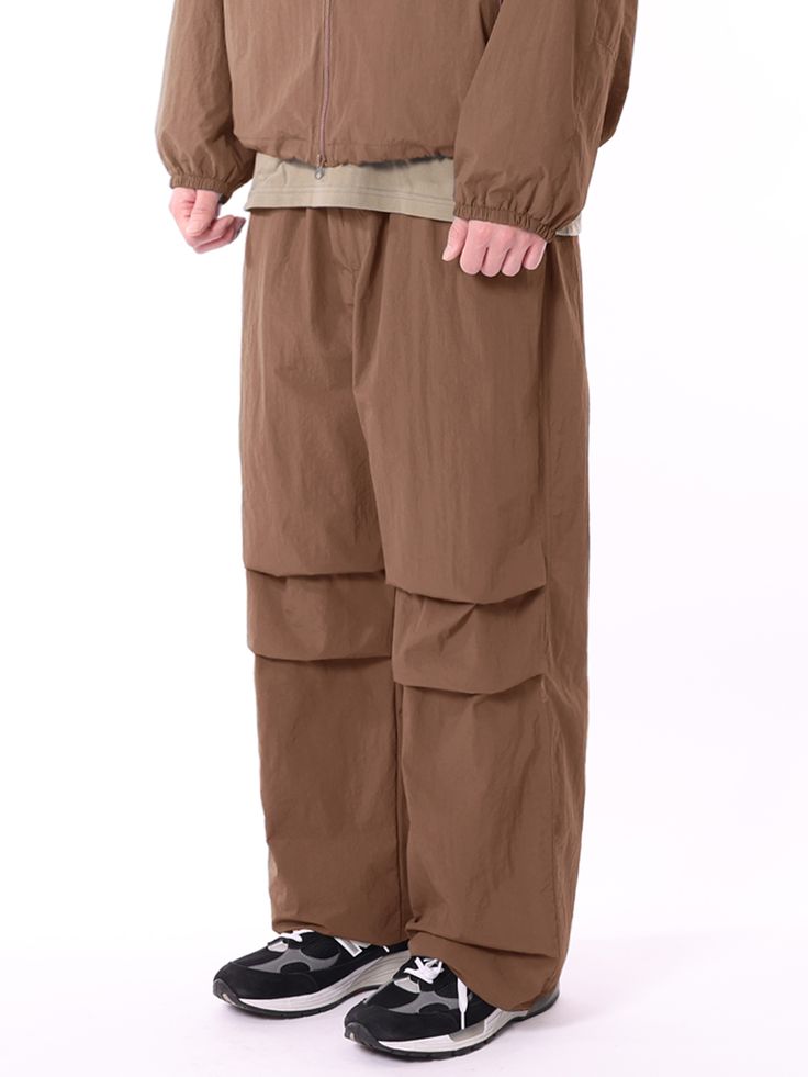 Editor's NotesTHAT`S IT's parachute pants has a trendy and casual look with natural wrinkles on the fabric, deep tuck, and string and stopper on the hem. You can style it with various items during multiple seasons. - Natural wrinkle on the fabric- Deep tuck for wide silhouette- String and stopper on the hemMeasurements (in.)M/L/XL- Length: 41.34 in. / 41.73 in. / 42.13 in.- Waist: 12.60 in. / 12.99 in. / 13.78 in.- Rise: 15.75 in. / 16.14 in. / 16.14 in.- Hip: 21.65 in. / 22.44 in. / 23.23 in.- Thigh: 14.17 in. / 14.57 in. / 14.96 in.- Hem: 9.84 in. / 10.24 in. / 11.02 in.* Model info: Height 6'1, Weight 143 lbs, Wearing size XLComposition & Care- Nylon 100%- Refer to care labelDesigner- by THAT`S IT Baggy Brown Cargo Pants For Spring, Spring Baggy Brown Cargo Pants, Brown Cargo Pants With Elastic Waistband For Spring, Spring Brown Cargo Pants With Elastic Waistband, Brown Spring Parachute Pants With Side Pockets, Brown Parachute Pants With Side Pockets For Spring, Brown Cargo Parachute Pants, Spring Brown Parachute Pants With Relaxed Fit, Brown Relaxed Fit Parachute Pants For Spring