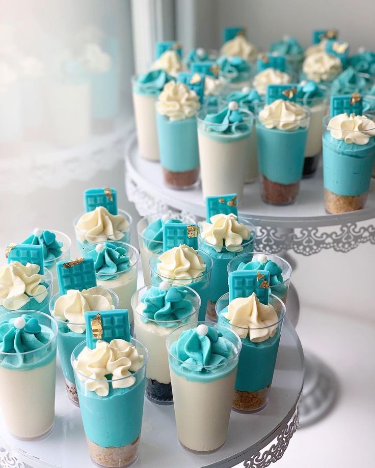 cupcakes with blue frosting and bows on them