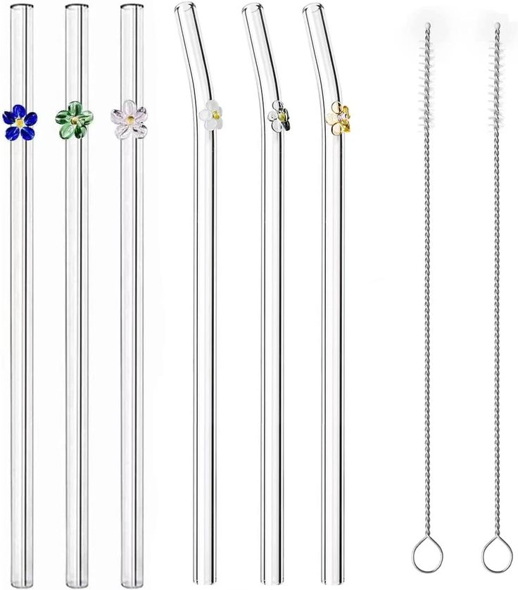 four different types of metal straws with flowers on them and one has a flower in the middle