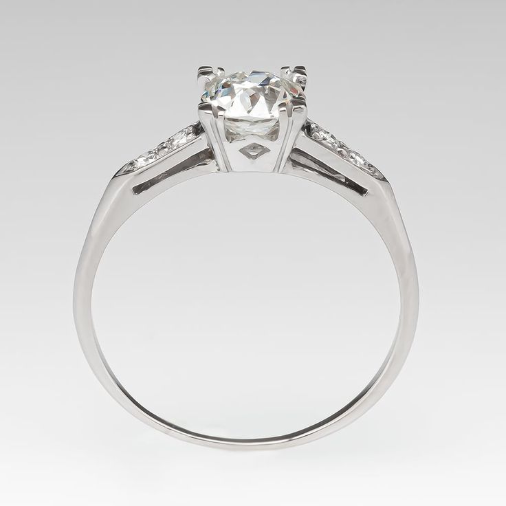 he vintage ring is centered with one (1) old mine cut diamond weighing 0.96 carat and set into a four-prong head. The shoulders of the ring are each accented with two (2), bead set, round brilliant cut diamonds. The ring measures 6.8mm at the top, rises 5.1mm above the finger, tapering to 0.8mm wide and 0.8mm thick at the base of the shank. Classic Platinum Ring With Classic Cut, Timeless Platinum Diamond Ring With Single Cut Diamonds, Classic Asscher Cut Platinum Diamond Ring, Heirloom Platinum Diamond Ring With Center Stone, Classic Platinum Rings With Brilliant Cut, Classic Platinum Diamond Ring, Timeless Platinum Ring With Classic Cut, Heirloom Platinum Diamond Ring With Classic Cut, Heirloom Asscher Cut Ring With Center Stone