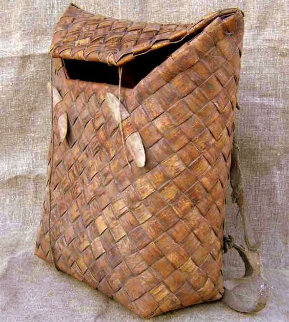 an old woven basket is sitting on the ground