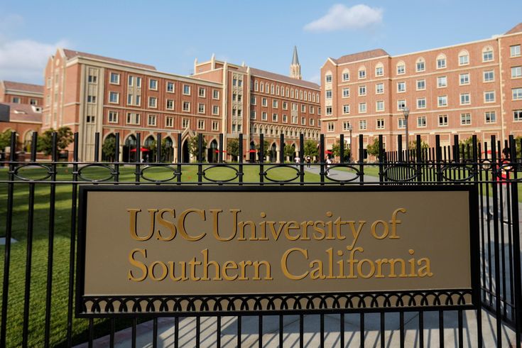 the university of southern california sign in front of an iron fence