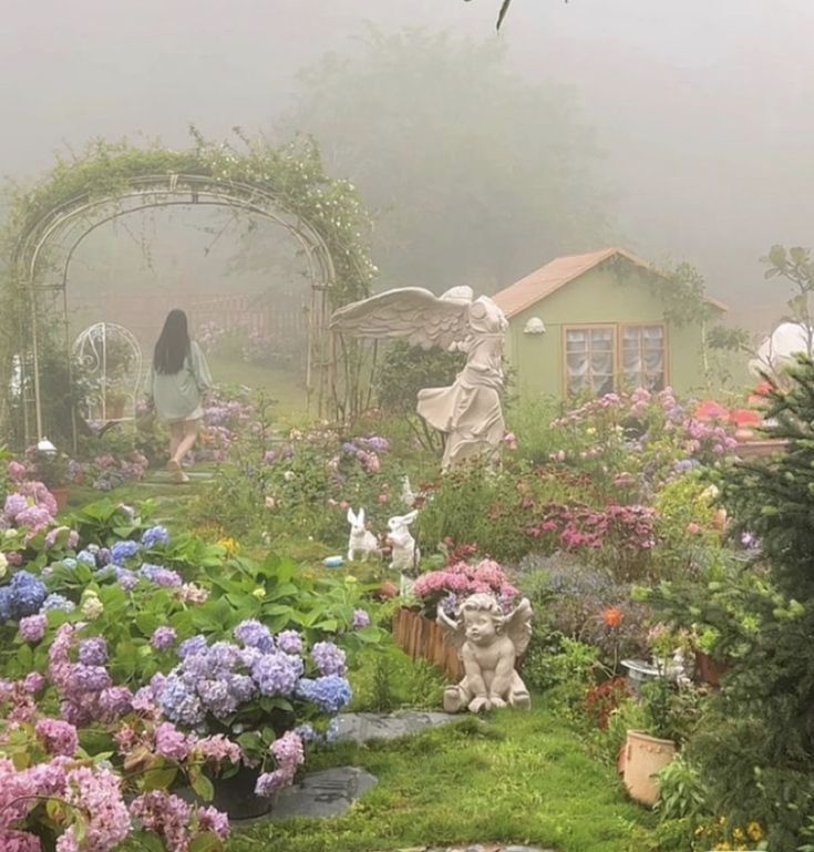 a garden filled with lots of flowers and statues