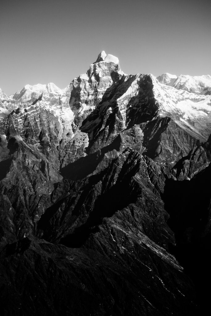 black and white photo of mountains with snow on them