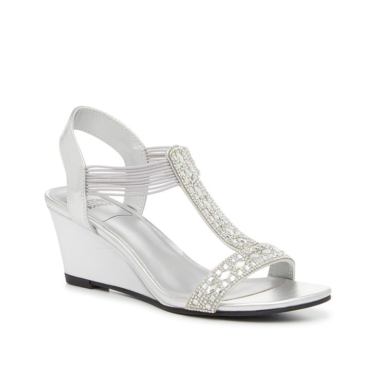 New York Transit-Frolic Wedge Sandal Add an elegant touch to your favorite formal looks with the Frolic sandals from New York Transit. This pair features a silver hue, a solid wedge heel, and decorative rhinestones along the straps. Silver Synthetic Wedge Sandals With Round Toe, Evening Slip-on Synthetic Wedge Sandals, Silver Sandals With 4-inch Heel For Cocktail, Dress Sandals Flat, Silver Wedge Heels With 4-inch Heel, Formal Crystal-embellished Wedge Sandals, Shoe Size Chart Kids, Bridal Wedding Shoes, Wide Width Shoes