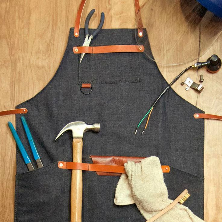 an apron and tools are laid out on the floor