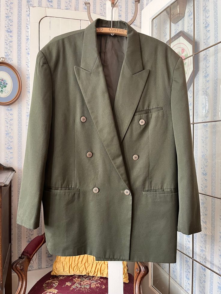 This jacket by Protocol is made from 65 per cent polyester and 35 per cent rayon in medium olive green. It is double breasted and has the original buttons in the front and on the cuffs, three front pockets and three inside pockets, and it's fully lined with silky dark green lining. Marked size 42. The measurements, taken with the jacket lying flat, ate: shoulder to shoulder, 21 inches; armpit to armpit, 23 inches; sleeves, 25 inches; length, 34 inches; bottom edge, 34 inches. In very good condit Green Sport Coat, Olive Green Blazer, Green Blazer, Double Breasted Jacket, Jacket Blazer, Sport Coat, Double Breasted, Olive Green, Dark Green