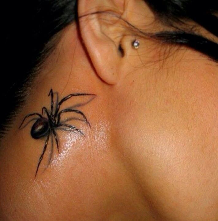 a woman's neck with a spider tattoo on her left side behind the ear