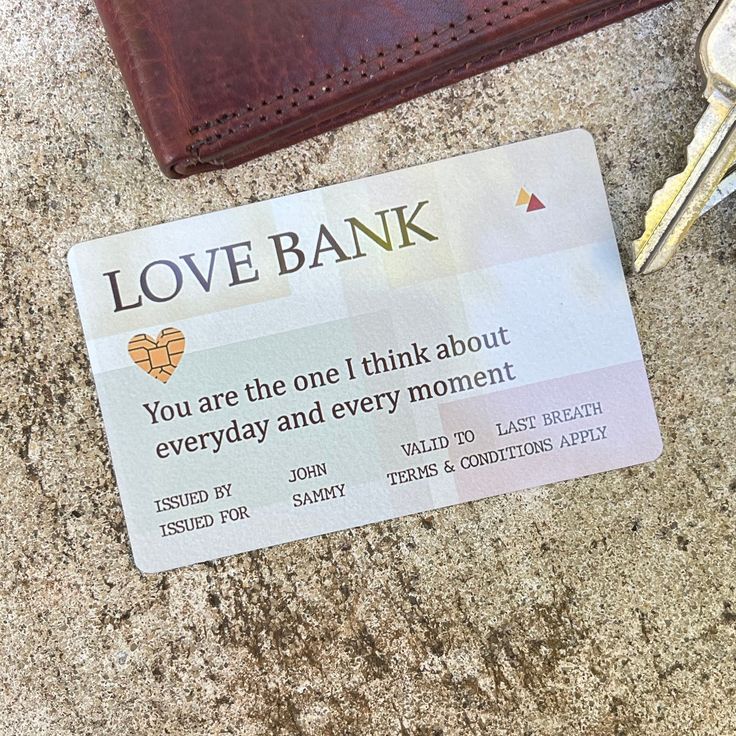 a love bank card sitting on top of a counter next to a wallet and keys