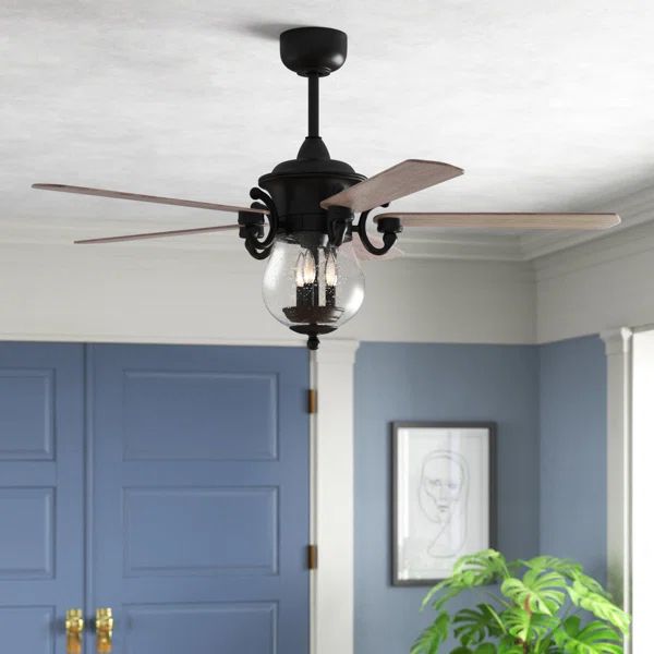 a ceiling fan that is hanging from the ceiling in a room with blue walls and doors