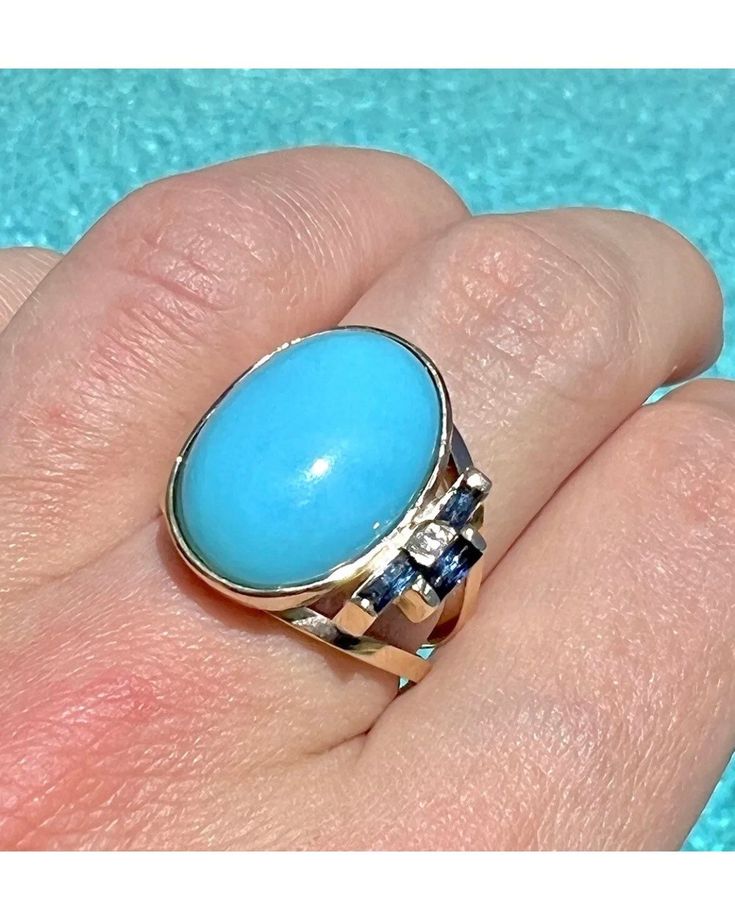 14k solid Yellow Gold 5ct Sleeping Beauty turquoise Modernist Handmade ring. Size 6.75 This ring is part of our handmade collection, every stone and style is handpicked by us to create the most beautiful pieces 8.40 grams Sapphire accents and diamond Heirloom Hallmarked Turquoise Ring For Formal Occasions, Heirloom Hallmarked Turquoise Ring For Formal Events, Heirloom Style Hallmarked Turquoise Ring For Formal Occasions, Heirloom Turquoise Gemstone Ring For Formal Occasions, Heirloom Style Turquoise Ring For Formal Occasions, Anniversary Oval Cabochon Turquoise Ring In Fine Jewelry Style, Elegant Oval Turquoise Ring With Accent Stones, Elegant Turquoise Ring Collectible, Oval Hallmarked Turquoise Ring For Anniversary