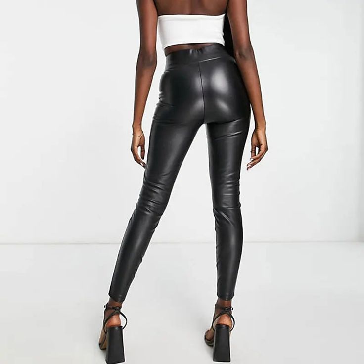 Discover the essence of sleek and modern style with our Sleek High-Waist Stretch Pencil Trousers. These trousers are a perfect blend of casual elegance and comfortable wear, suitable for all seasons. The high waist design not only adds a touch of sophistication but also provides a flattering fit for various body types. Crafted with a medium stretch fabric, these trousers ensure both comfort and a figure-hugging silhouette. The PU faux leather material, combined with spandex, offers a luxurious feel and a flexible fit, making these trousers ideal for day-long wear. Featuring a solid pattern and a classic pencil pant style, these trousers are a versatile addition to your wardrobe. Whether it's a day at the office or a casual evening out, these trousers adapt effortlessly to any setting. The Fitted Black Modern Bottoms, Fitted Modern Black Bottoms, Modern Fitted Black Bottoms, Versatile Fitted Leggings For Night Out, Fitted Leggings For Night Out, Sleek Leather Pants For Going Out, Sleek High Waist Leggings, Sleek Black Leggings For Workwear, Fashion-forward High Waist Workwear Bottoms