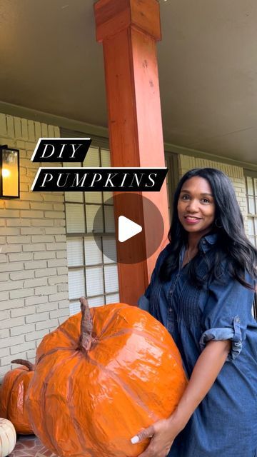 a woman holding a giant pumpkin in front of a house with the words diy pumpkins on it