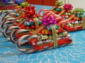 candy canes wrapped in bows and ribbons on a table