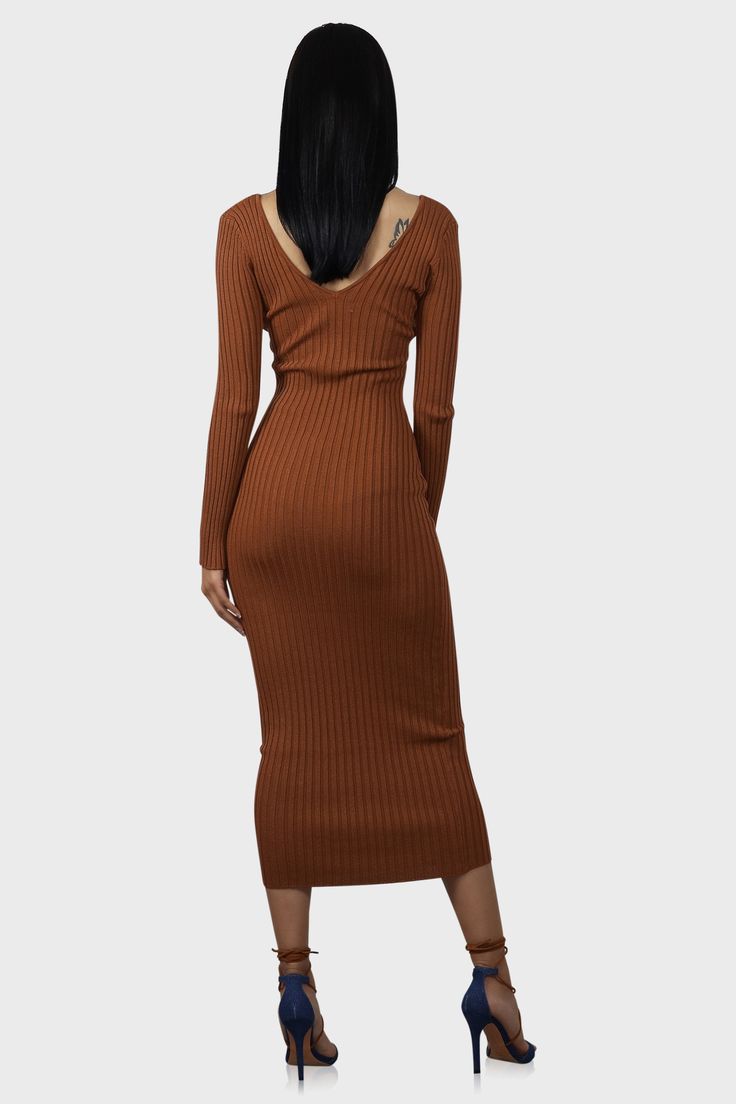 This midi sweater dress is anything but basic! Features a v-neck and ribbed knit with plenty of stretch. Complete the look with your favorite leather jacket. Color: Rust Model wearing size Small Size S measures 53" from center back to hem Runs true to size Fabric has stretch 70% Rayon /30% Nylon Hand wash cold Ribbed V-neck Sweater Dress For Date Night, Fall Ribbed Sweater Dress In Midi Length, Brown Ribbed V-neck Dress, Long Ribbed Sweater Dress For Fall, Brown Ribbed Sweater Dress For Fall, Ribbed Brown Sweater Dress For Fall, Chic Sweater Dress With Ribbed Neckline For Fall, Fall Ribbed Brown Sweater Dress, Winter Brown Ribbed Midi Dress