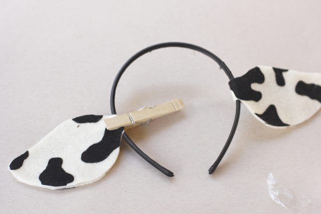 a pair of black and white cow print headbands with hair clips attached to them