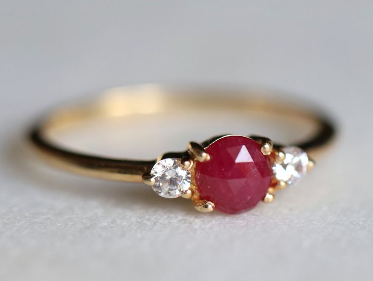 Ruby ring, Engagement ring, Ruby engagement ring, Diamond and Ruby stacking ring, Natural ruby ring, dainty promise ring, ruby ring Same design can be made also with other custom gemstones per request. Product details: - Solid gold (9k, 14k) - approx 5mm ruby round - 2.5mm Diamonds ( G, VS-SI ) - Band size is 1.4mm - Made to order - 8 to 10 business days. Ring size - US 3 to US 9 (for smaller or larger ring size, please contact) Please select your size at the drop down menu. Service Available - Classic Red Promise Ring, Red Ruby Cluster Ring With Round Cut, Formal Red Ruby Ring With Three Stones, Formal Ruby Three Stone Ring, Formal Red Three Stone Ruby Ring, Classic Red Three Stone Diamond Ring, Luxury Red Three Stone Jewelry, Classic Red Three Stone Rings, Luxury Red Three-stone Jewelry