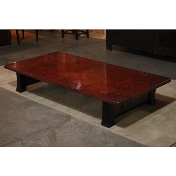 a wooden table sitting on top of a carpeted floor