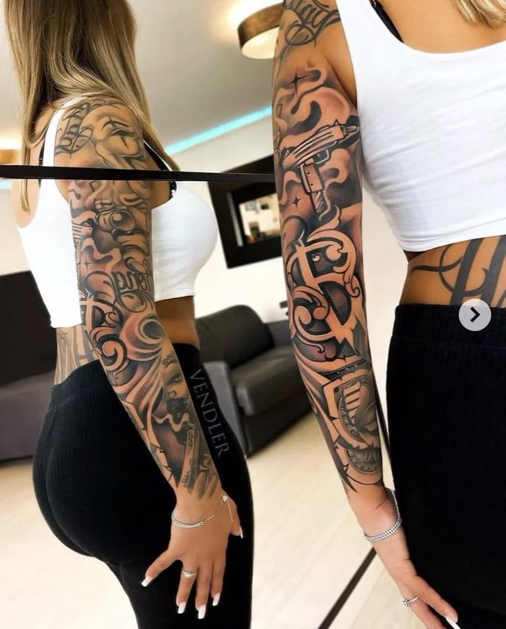 two women with tattoos on their arms