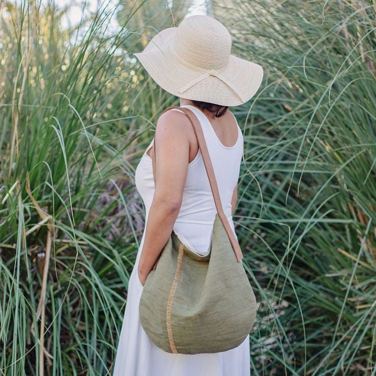 Say hello to your new favorite tote! Our gorgeous Archer tote features handcrafted detailing and ample room for all of your everyday adventures. From books to a light sweater, these jute tote bags provide plenty of carrying space, plus interior pockets to keep your cell phone or wallet tucked away. Our Archer tote features a jute canvas exterior and interior cotton lining, along with a strong, leather handle. You’ll find two interior pockets and a snap closure to help keep your belongings organized and secure. Available in indigo, olive or natural, these thoughtfully designed tote bags are not only lovely on their own, they’re sure to complement your favorite ensemble! Details: Dimensions: 16” H x 15” W, handle drop 13” Material: Jute, cotton Details: Features two interior pockets, one wit Palm Leaf Baskets, Holiday Lookbook, Jute Basket, Jute Tote Bags, Jute Totes, Vintage Cushions, Twist Top, Everyday Adventures, Black Ballet Flats