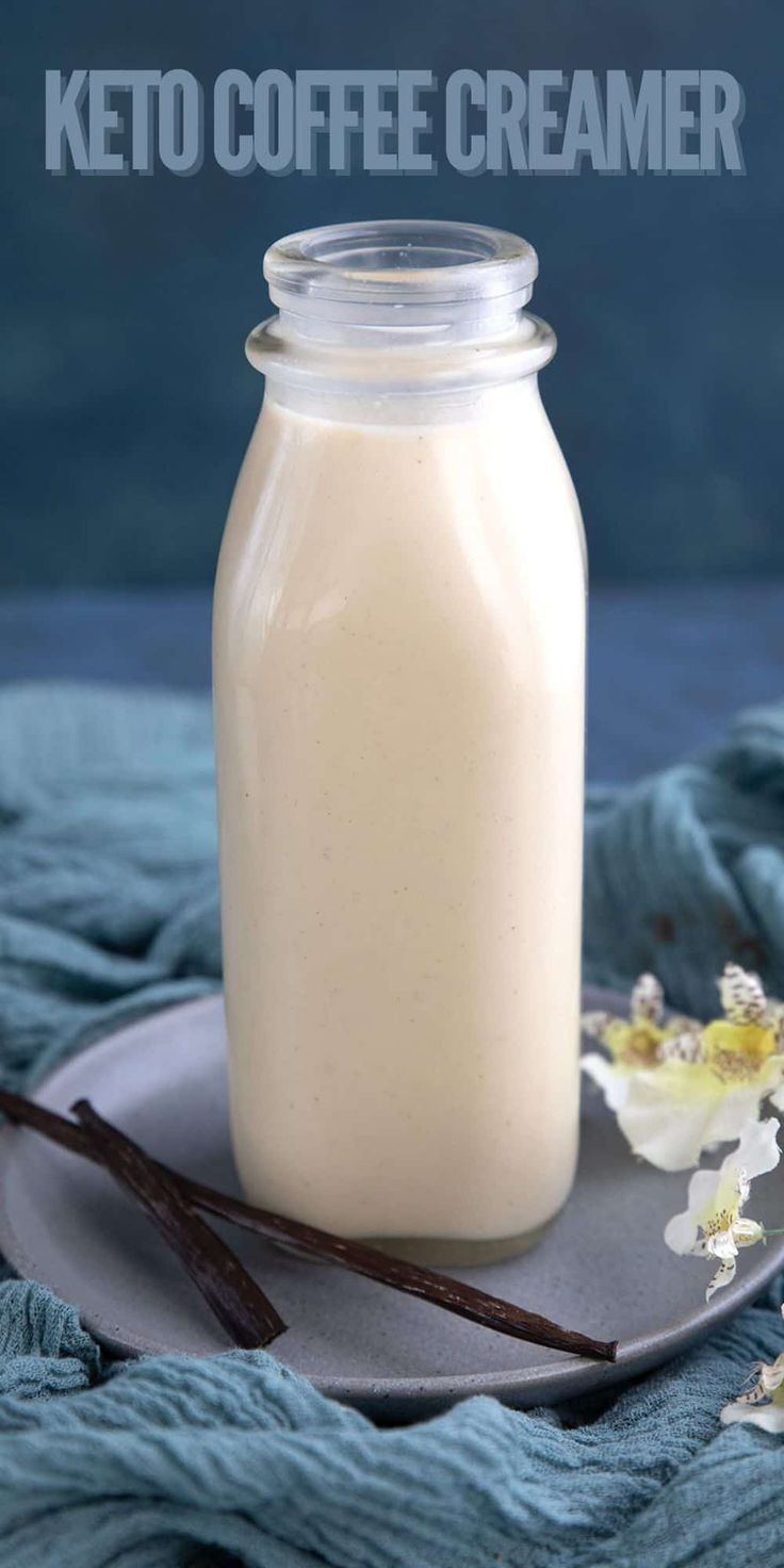 a glass jar filled with coffee creamer sitting on top of a plate