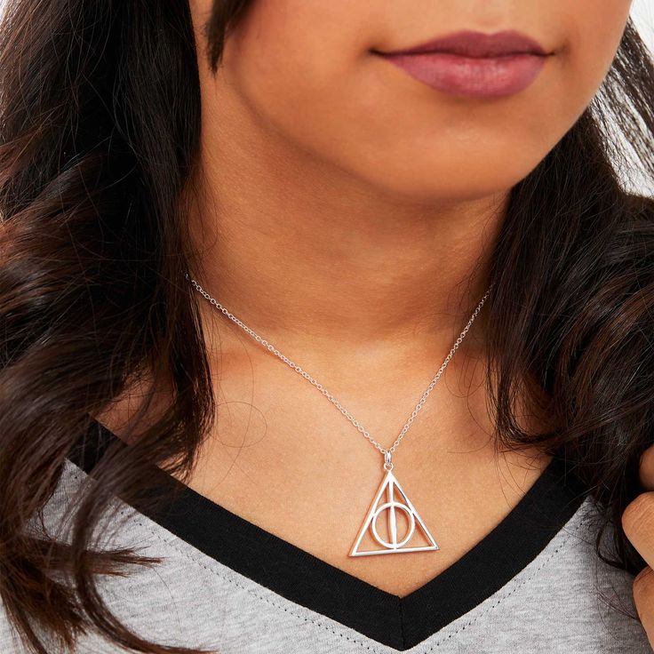 Complement your Harry Potter fan gear with this Deathly Hallows necklace, crafted from silver-flash plated brass with a lobster-clasp closure. Silver-flash plated Brass 18" Chain Spring ring closure Officially Licensed Harry Potter Jewelry Includes Complimentary Harry Potter Gift Box Themed Sterling Silver Charm Necklaces, Themed Sterling Silver Necklace, Themed Sterling Silver Necklace In Silver, Themed Sterling Silver Nickel Free Necklaces, Themed Sterling Silver Nickel-free Necklace, Adjustable Themed Sterling Silver Necklace, Silver Themed Pendant Jewelry, Themed Silver Pendant Jewelry, Themed Silver Stainless Steel Jewelry