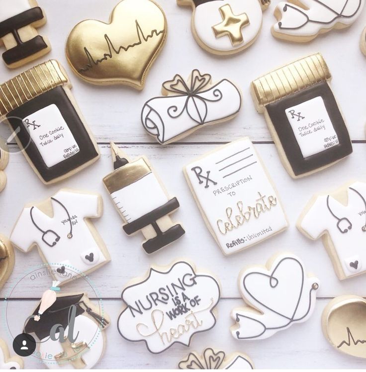 cookies decorated with medical related items are arranged on a white surface, including a stethoscope