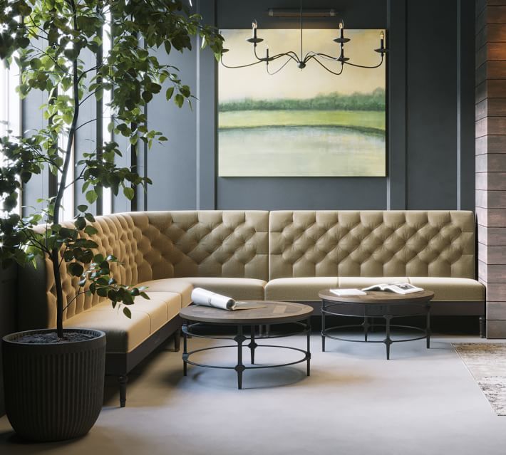 a living room filled with furniture next to a fire place and a painting on the wall