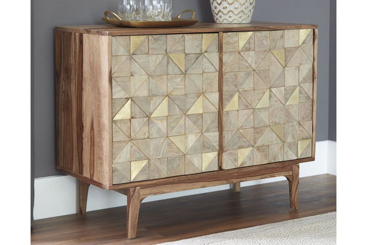 a wooden cabinet sitting on top of a hard wood floor next to a white rug